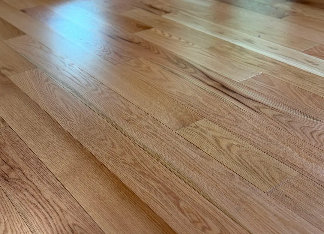 Smooth wooden floor with natural grain texture.