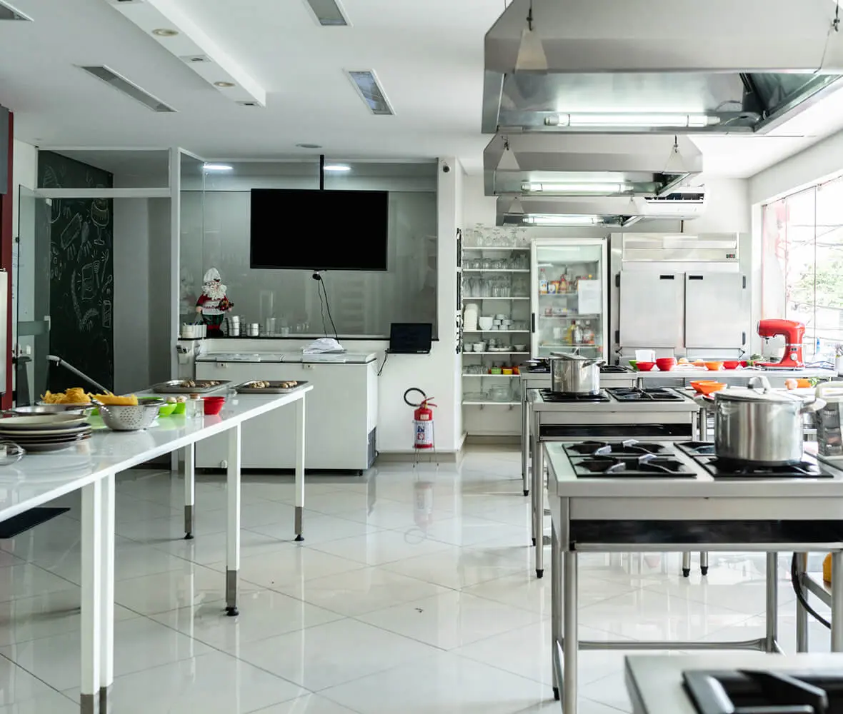 Professional kitchen with stainless steel equipment.