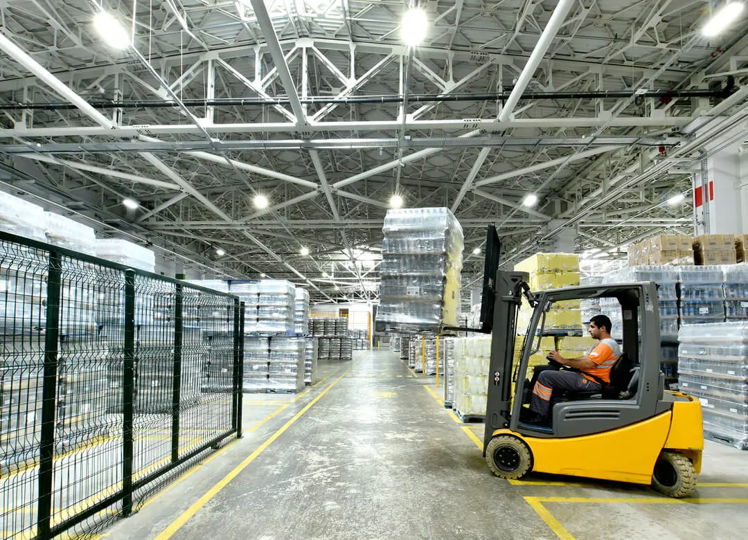 Forklift in a large warehouse setting.