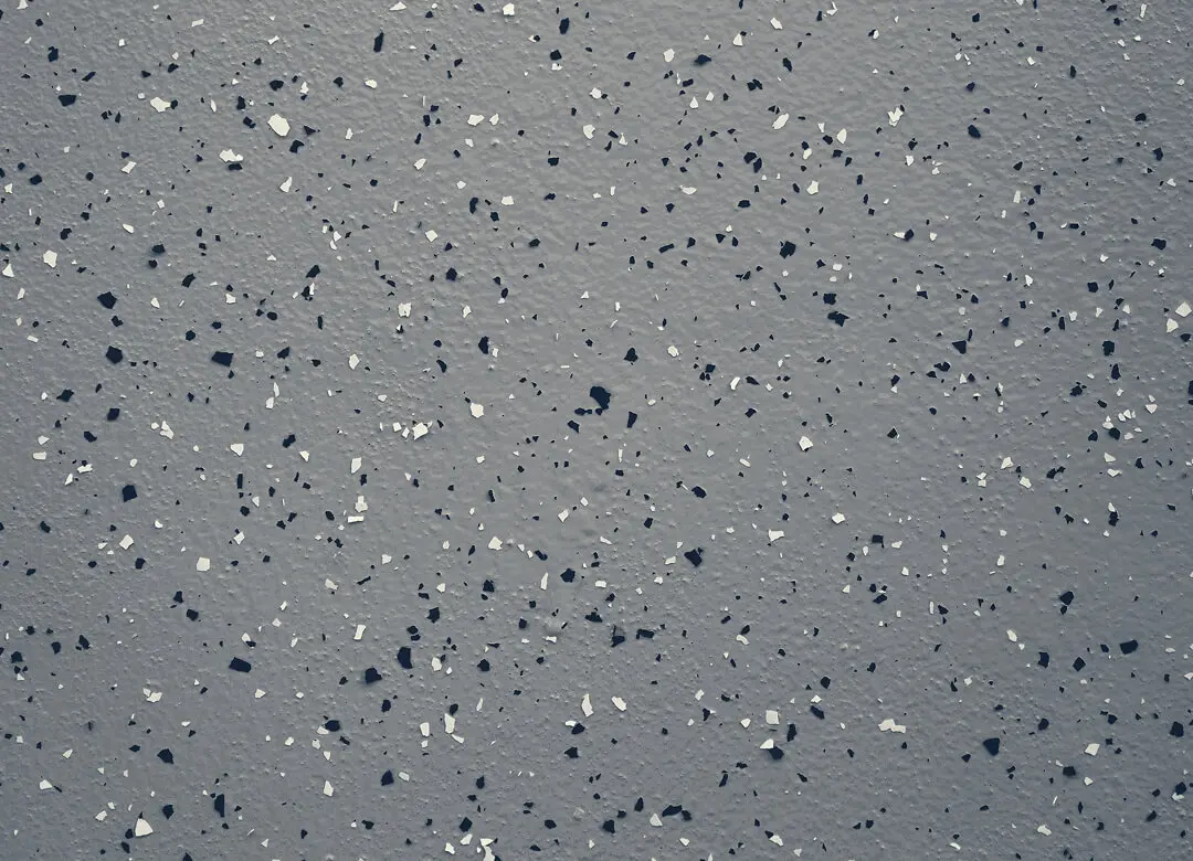 Gray speckled floor with black and white flecks.