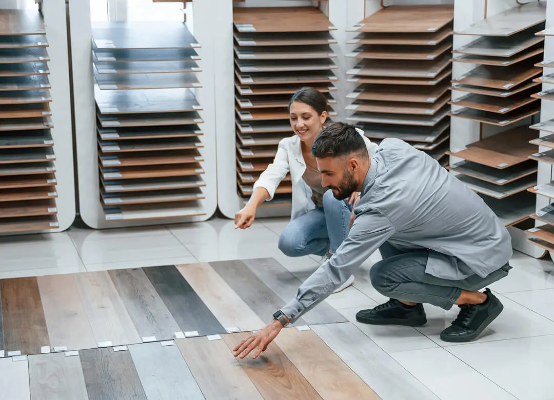 Couple choosing laminate flooring in a store.