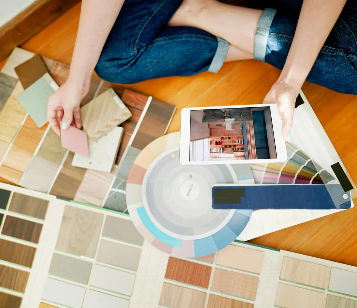 Person selecting colors with tablet and samples.