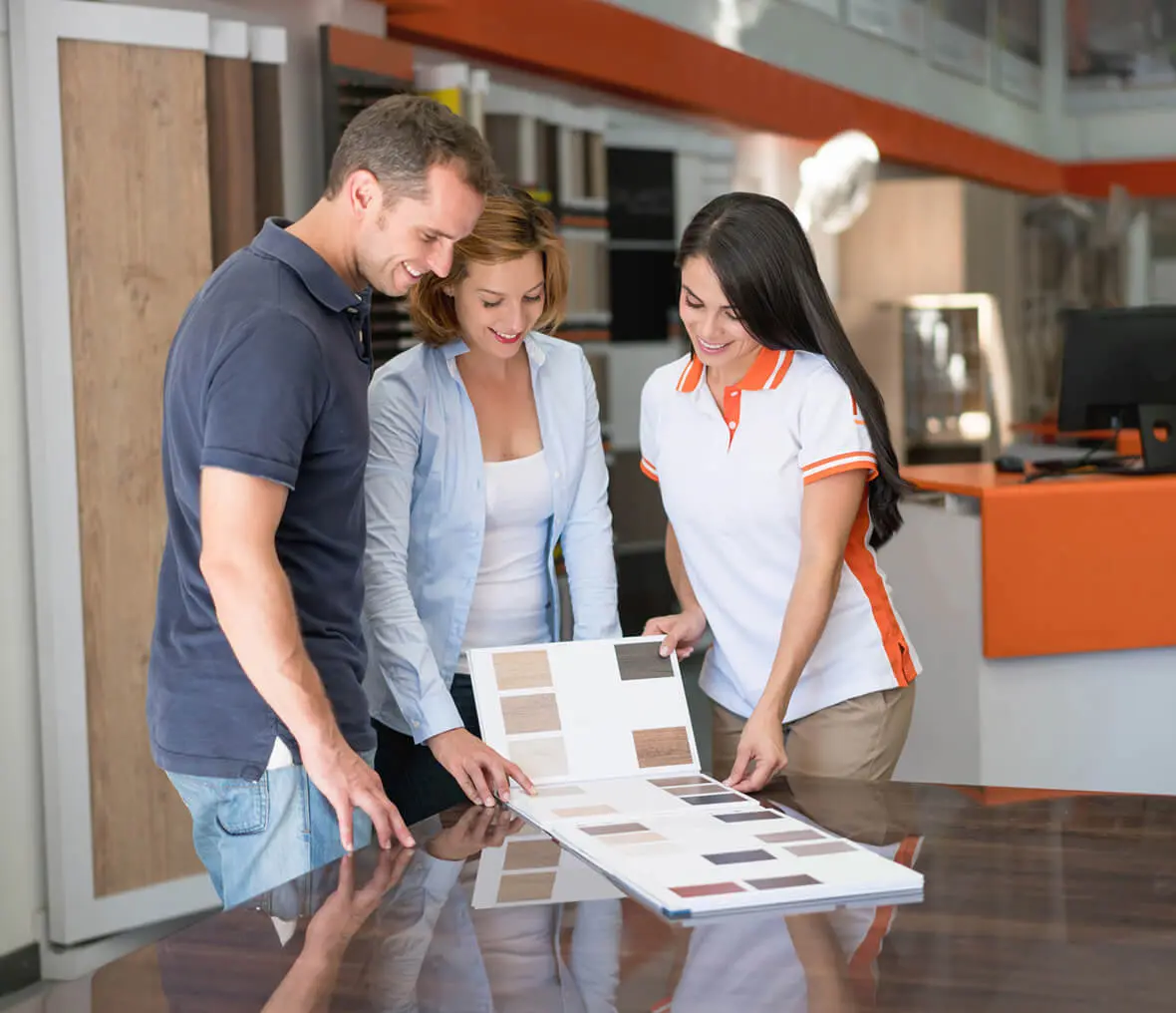 People choosing colors from a sample book.