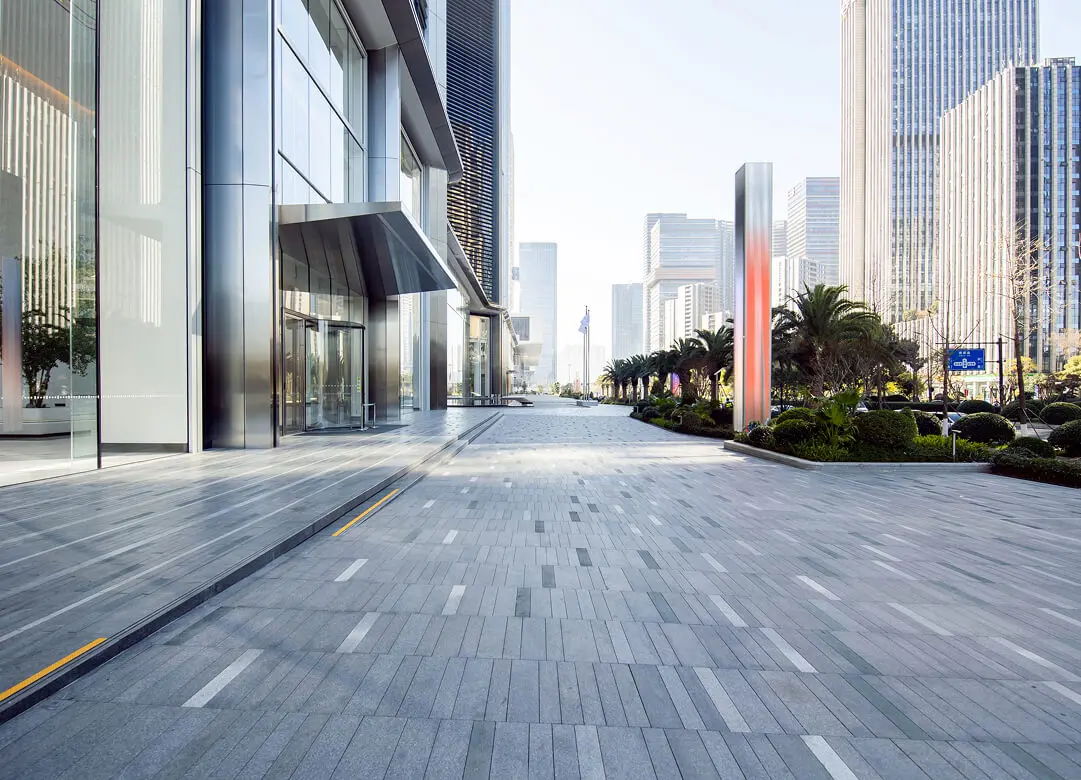Modern cityscape with tall buildings and walkway.