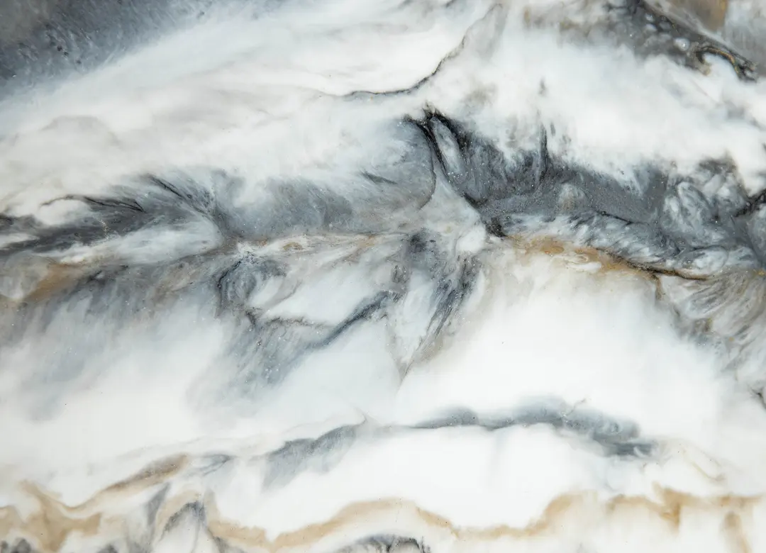 Marble texture with gray and beige swirls.