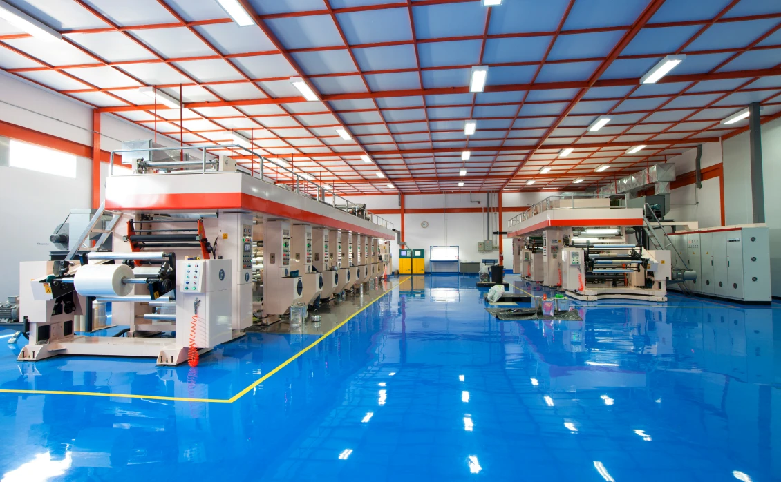 Industrial printing machines in factory setting.